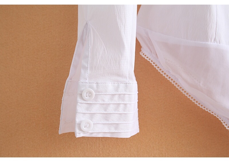 White bodysuit with long sleeves on a beige background
