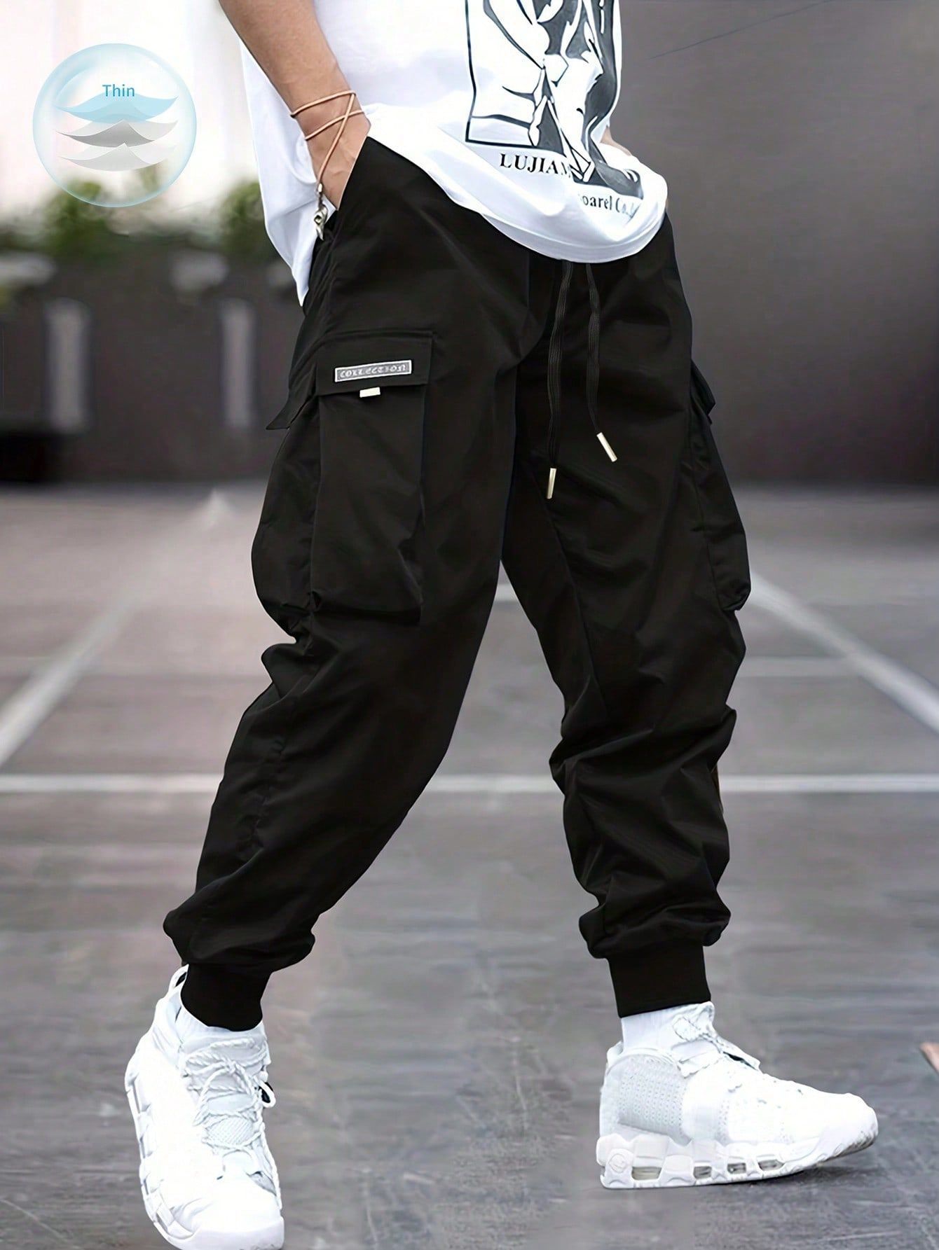 Black cargo jogger pants with pockets and cuffs, white sneakers.