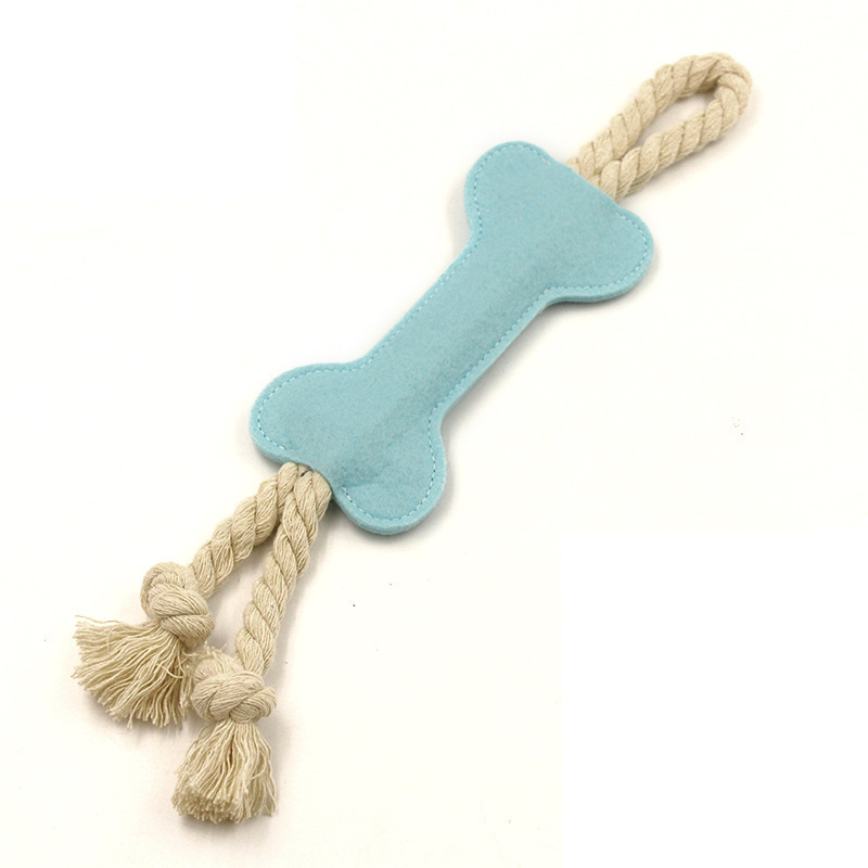 Dog playing with felt bone chew toy outdoor portable