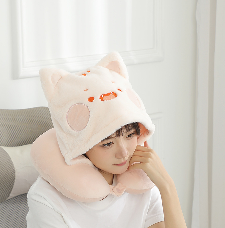 Person wearing the pink kitten hooded U-shaped pillow