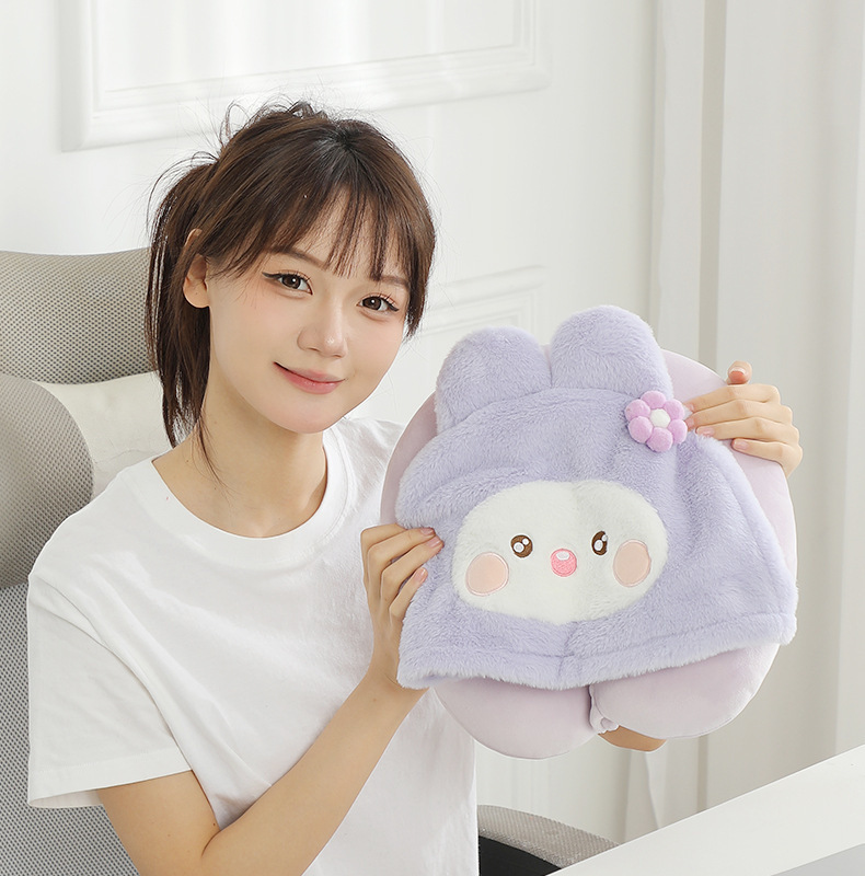 Person holding the lavender rabbit hooded pillow
