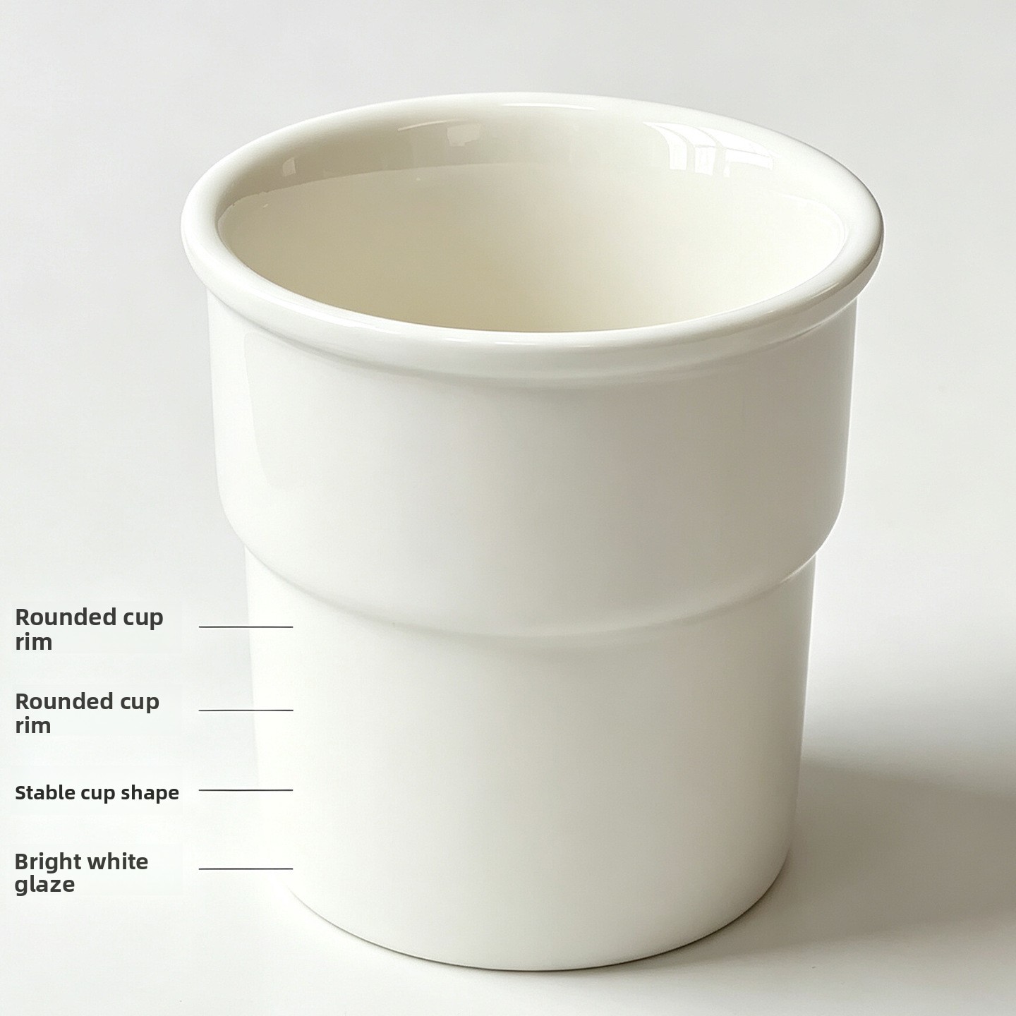 Hand holding a white ceramic cup