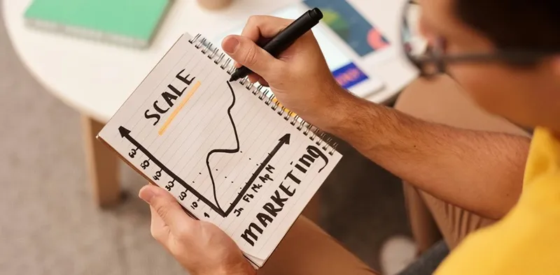 A man is analyzing and researching how to scale his business