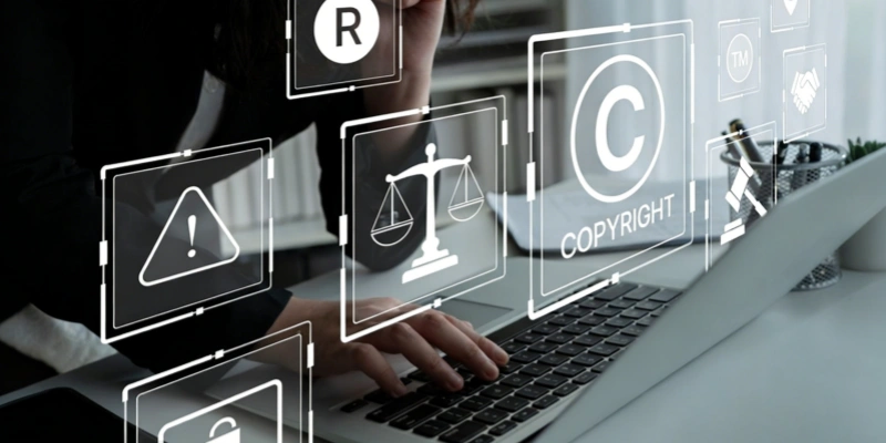 Person typing laptop with floating copyright legal icons