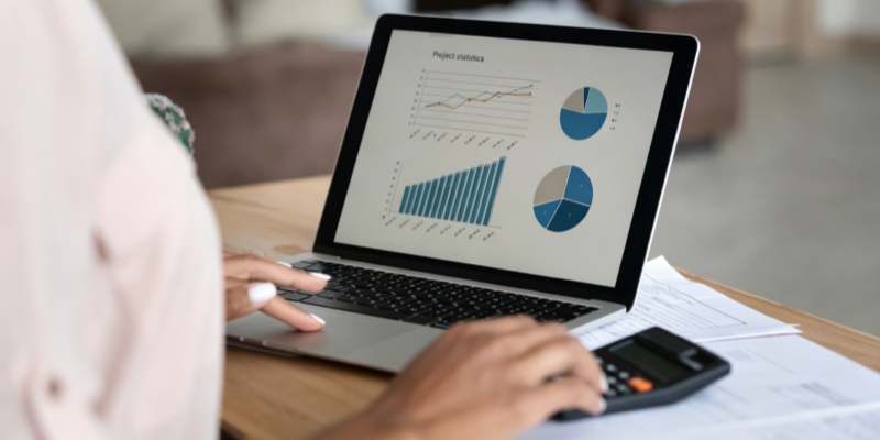 E-commerce business data analysis laptop screen financial charts calculator