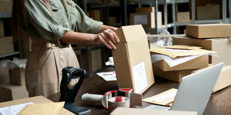 A woman packing dropshipping orders in warehouse
