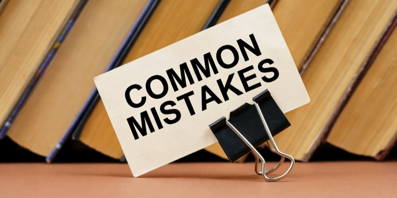 Note with COMMON MISTAKES clipped to stack of books