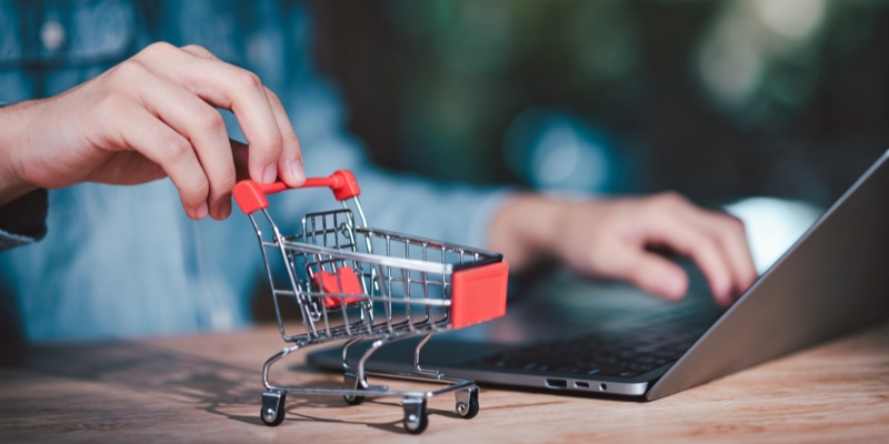 E-commerce online shopping mini cart laptop keyboard hand
